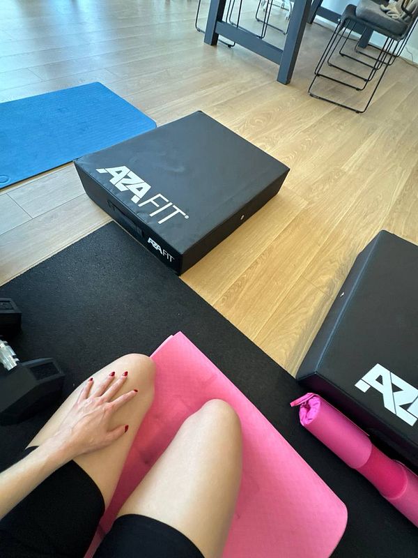 A workout space featuring fitness equipment and a person preparing for exercise.