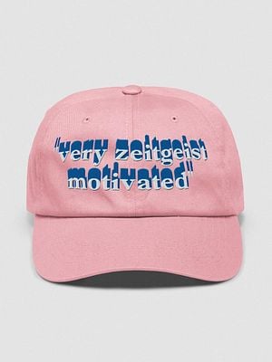 A pink baseball cap featuring the phrase 'very zeitgeist motivated' in bold text.