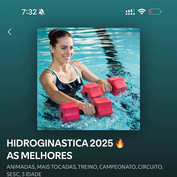 A woman is engaged in water aerobics, using pink dumbbells in a swimming pool.