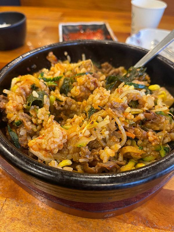 A bowl of bibimbap filled with a colorful mix of ingredients.