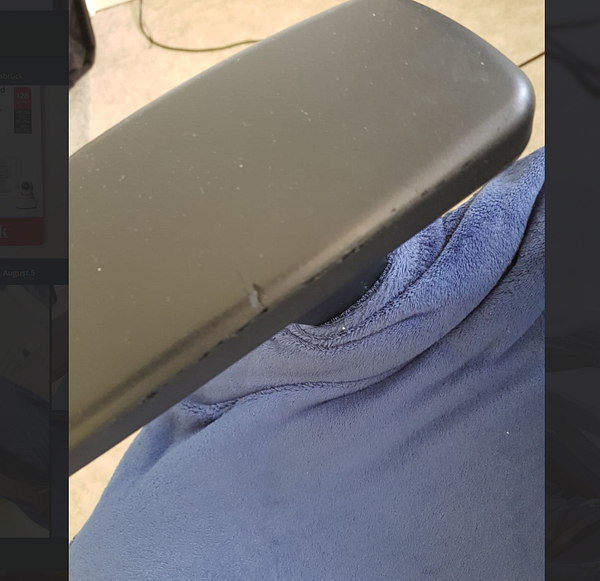 Close-up image of a beige armrest foam replacement for a chair.