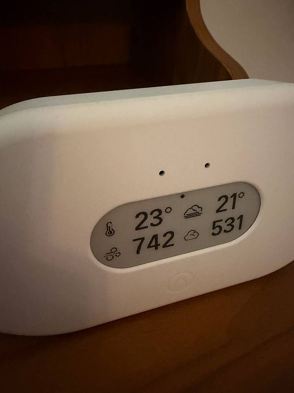 A hotel room thermostat display showing the current and set temperature in a luxury hotel suite.