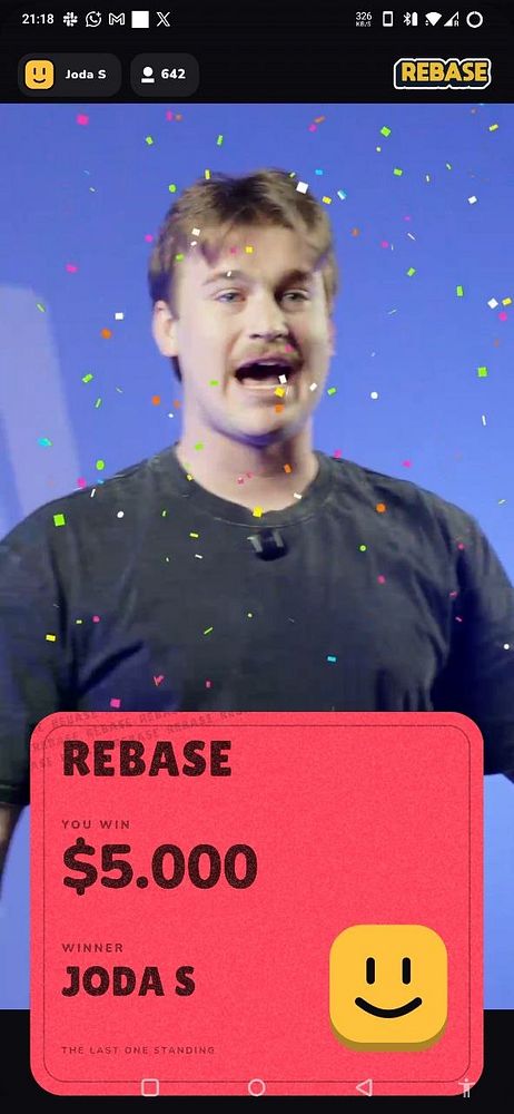 A man celebrates winning $5,000 in a Rebase.tv feud game as confetti falls around him.