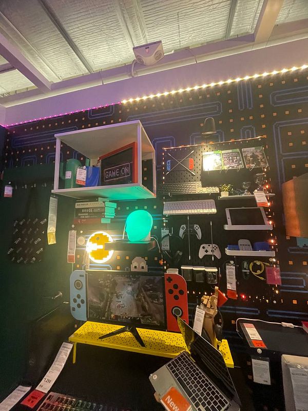 A vibrant workstation setup featuring gaming elements and colorful decor.