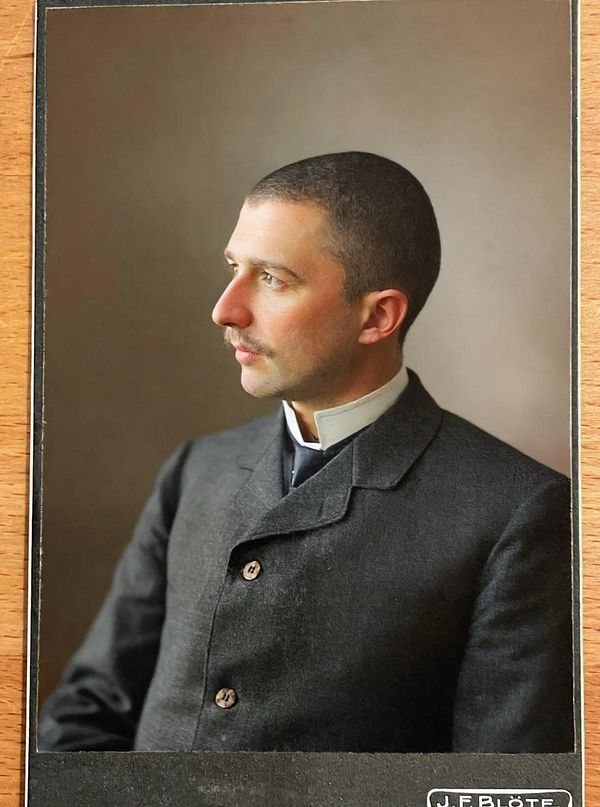 A vintage portrait of a man in formal attire, showcasing a detailed colorization of an old photograph.