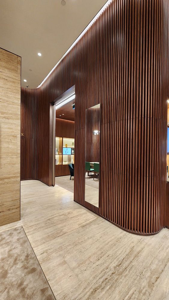 The image captures the interior of a luxurious Rolex boutique featuring elegant wooden paneling and a sophisticated layout.