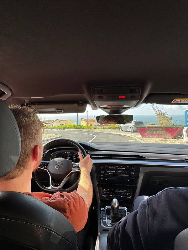 A person is driving a car for the first time in 20 years, with a focus on the dashboard and road ahead.