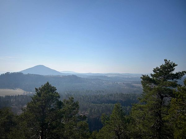 A scenic view of a mountainous landscape under a clear blue sky.
