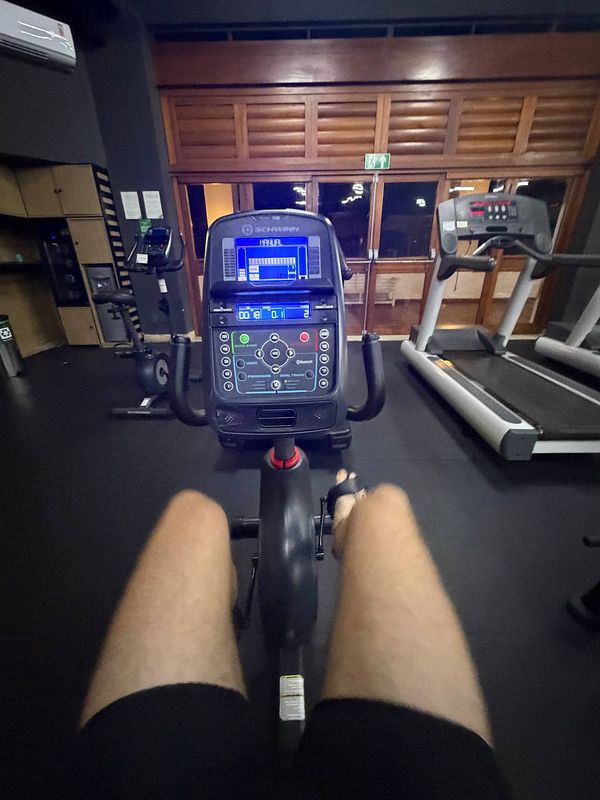 Interior of a hotel gym featuring various exercise equipment including treadmills and stationary bikes.