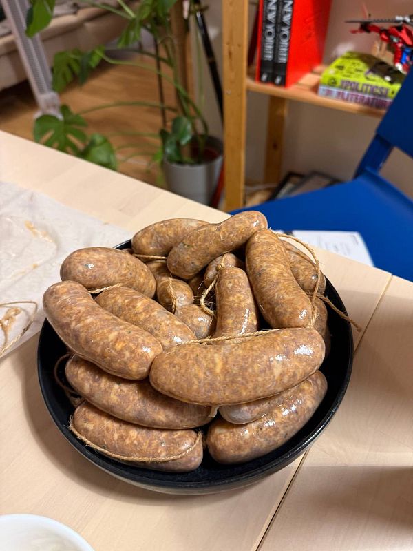 Close-up of raw pork meat pieces prepared for making sausages.