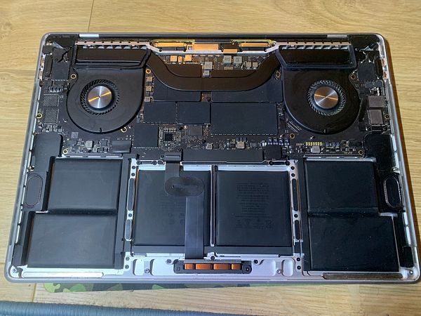 The image displays the internal components of a laptop, specifically the underside of the device with various hardware elements exposed.
