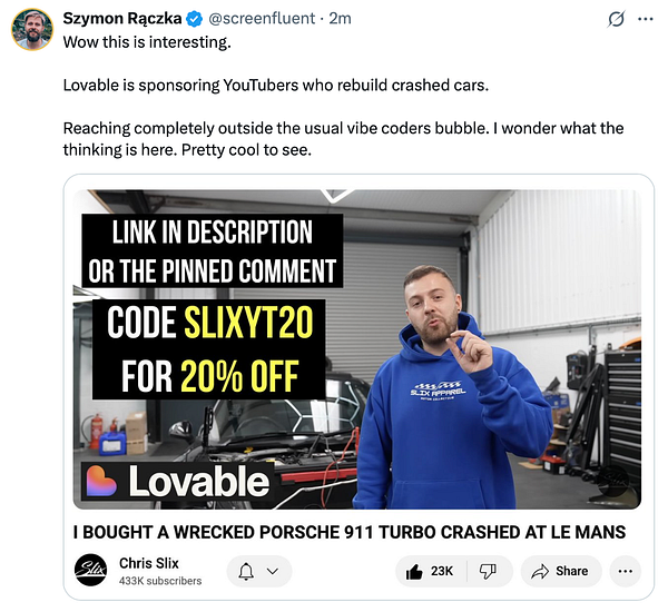 A YouTuber discusses a sponsorship from Lovable while standing in a garage with a crashed car in the background.