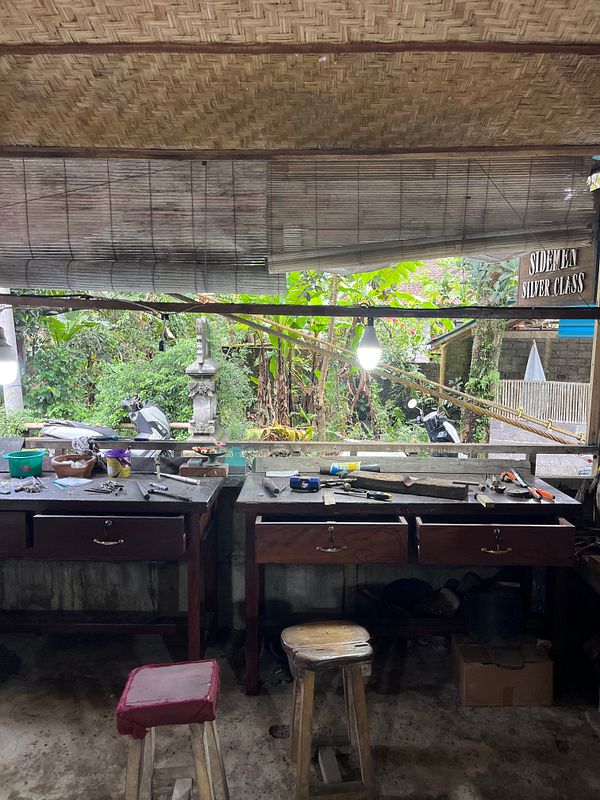 The image depicts a workshop space for a silver class, featuring workbenches and tools.
