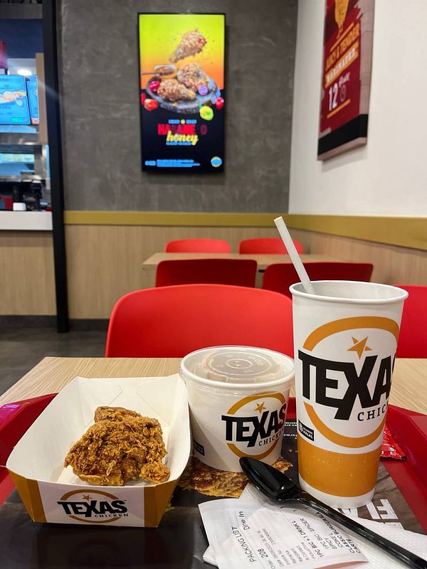A meal from Texas Chicken is displayed on a tray in a fast-food restaurant setting.