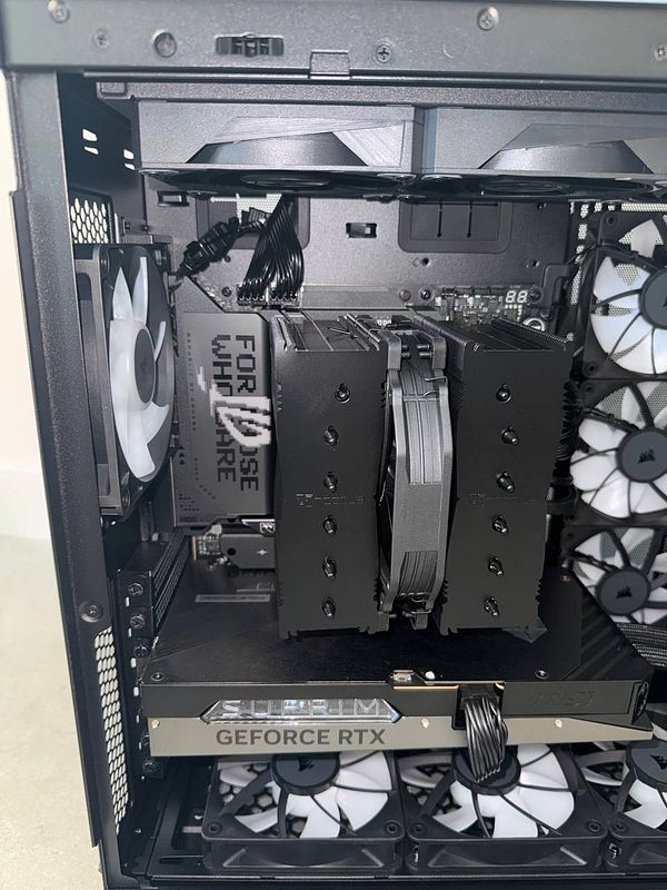 The image depicts a partially assembled high-performance gaming computer with a CPU cooler that is not fully attached.