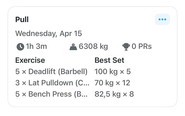 Man and woman exercising in a gym using a stairmaster and lifting weights.