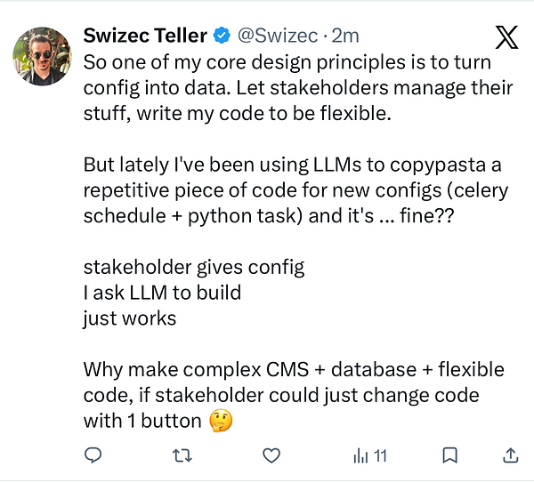 Photograph of an icebreaker ship navigating icy waters with snow-covered mountains in the background under a cloudy sky.