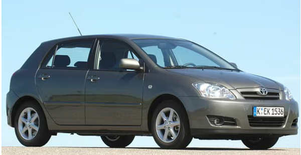 Front view of a 2006 Toyota Corolla parked on a street with a visible license plate and surrounding cars.