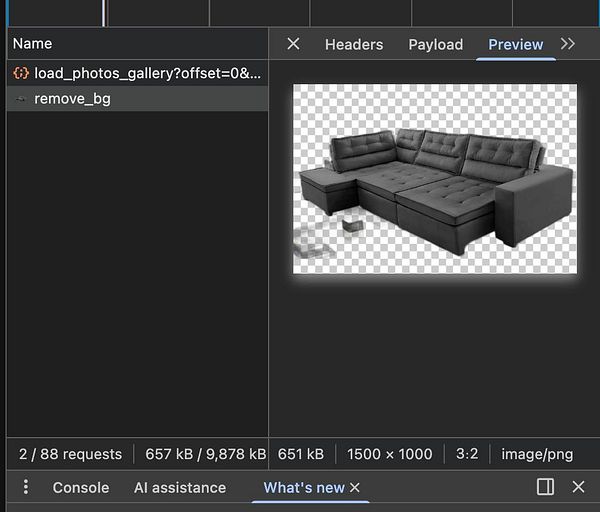 A photo showing a modern bedroom interior with a bed, furniture, and large windows with curtains.