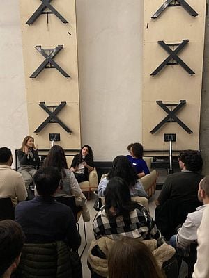 A panel discussion featuring three women in front of an audience.