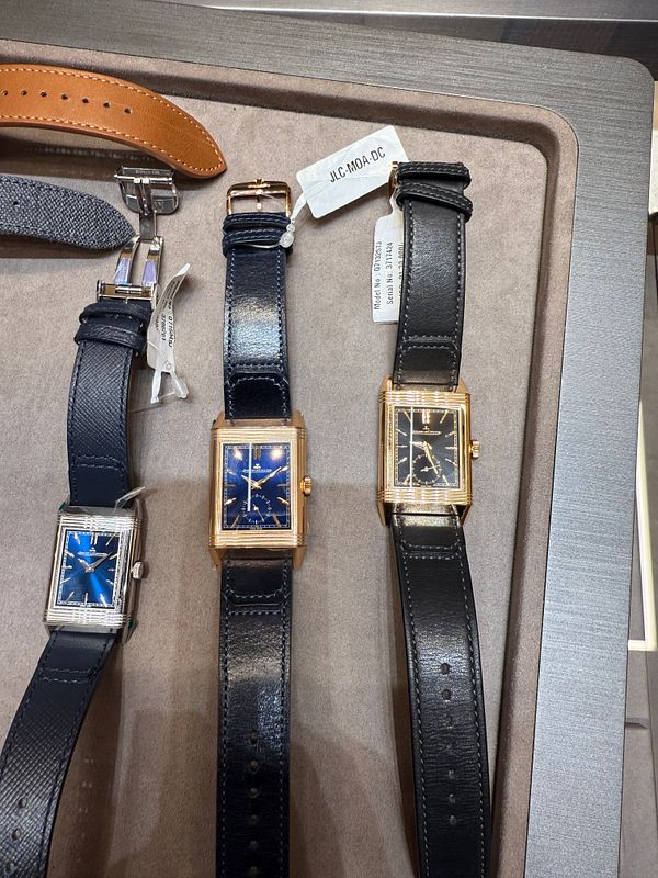 The image displays a selection of JLC watches arranged on a display tray.