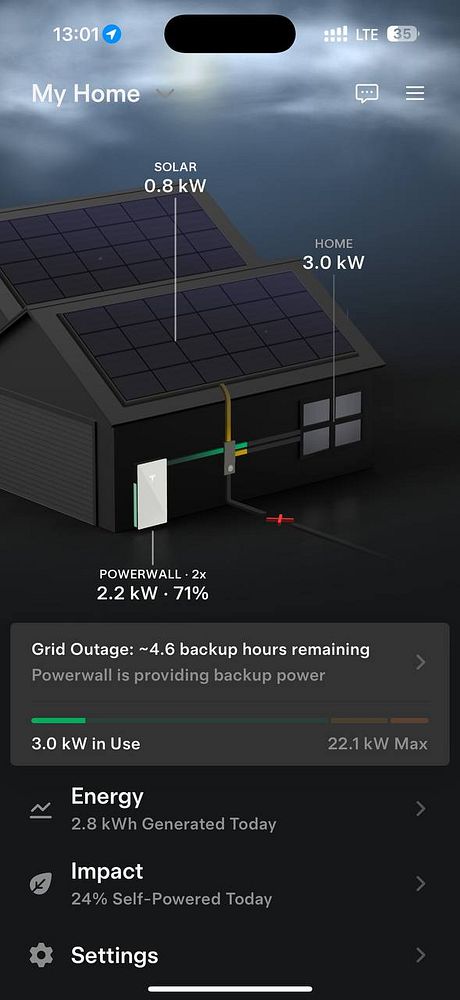 A man cooking steak on a Tesla Powerwall unit outdoors during a power outage.