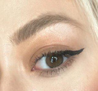 A close-up of a woman's eye showcasing makeup details.