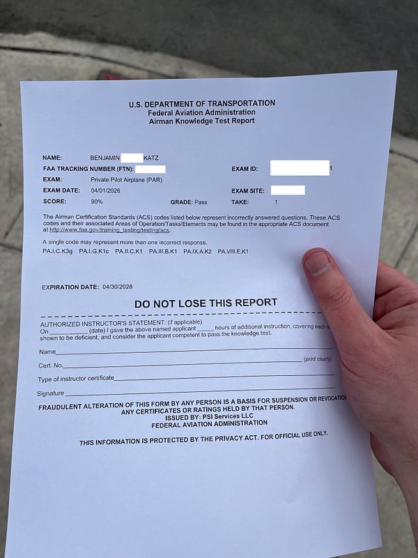 Photo of a desk with the FAA Private Pilot Knowledge Test results summary, showing a 90% score with detailed answers and review options.