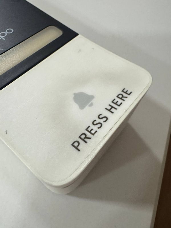 A close-up view of a Tapo doorbell with a prominent 'PRESS HERE' label.