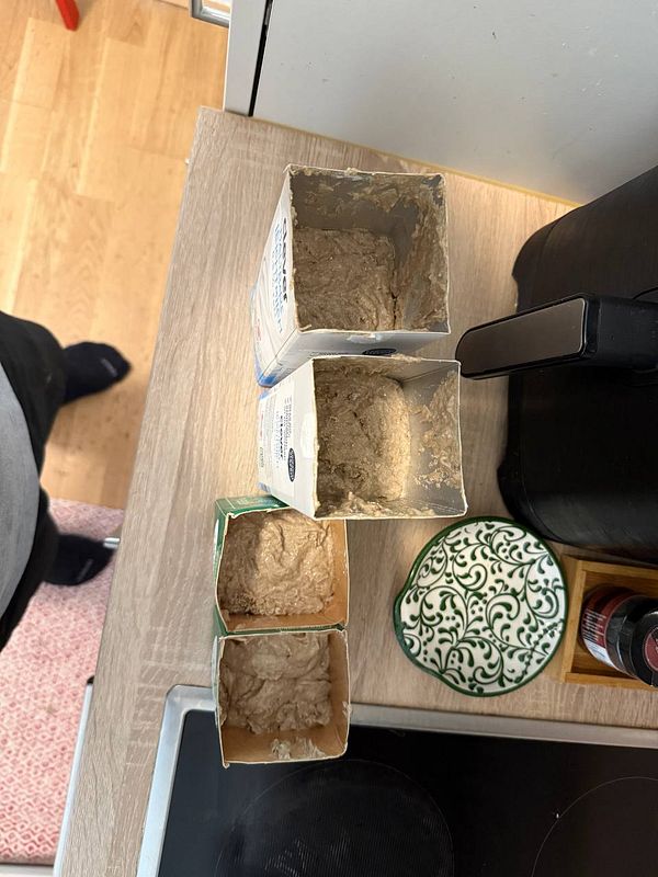 The image features several containers of dough or batter on a kitchen countertop.