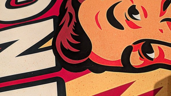 The image features a close-up of a colorful graphic design, likely from a promotional material or packaging.