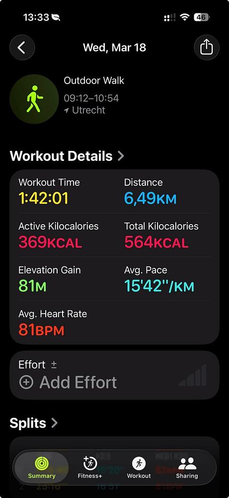 Silhouettes of two people walking against a dramatic sunset sky with vibrant orange and blue hues.