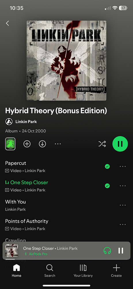 A modern kitchen with wooden cabinetry, a kitchen island, and a large window letting in natural light.