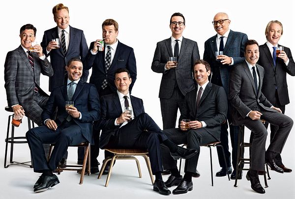 A group of prominent late-night talk show hosts poses together in a stylish photo.