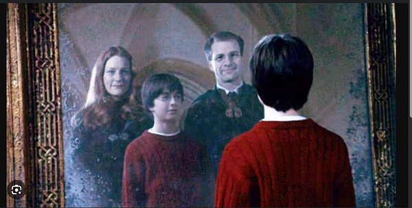 A scene from 'Harry Potter and the Sorcerer's Stone' featuring Harry Potter gazing into the Mirror of Erised.