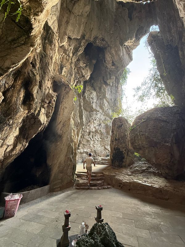 A person walks through a rocky cave in the Marble Mountains, Da Nang.