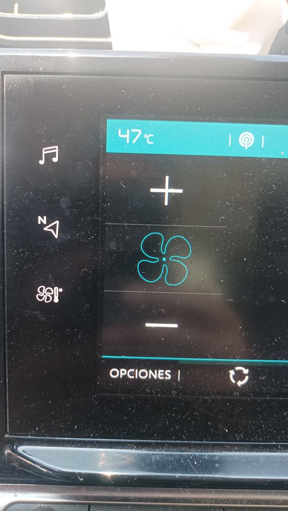 The image displays a car's digital dashboard showing a temperature reading of 47°C.