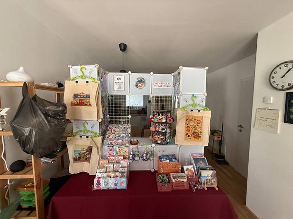 A prototype booth setup displaying various handmade items in a cozy indoor space.