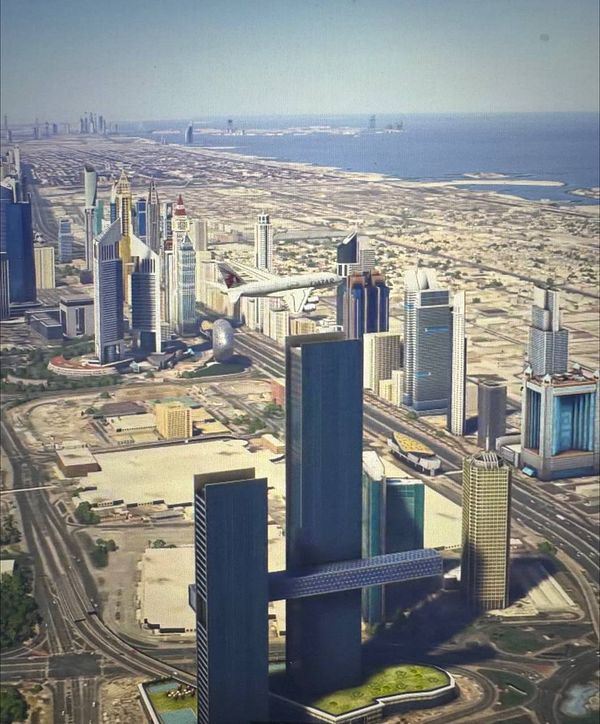 Aerial view of Dubai's skyline featuring modern skyscrapers and an airplane in flight.
