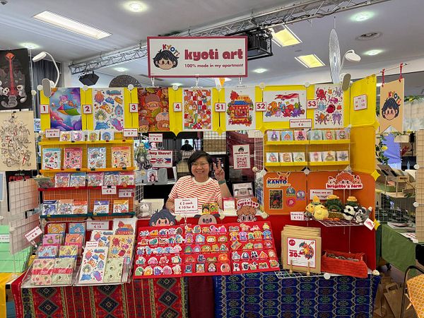 Hands holding a set of keys on a yellow background.