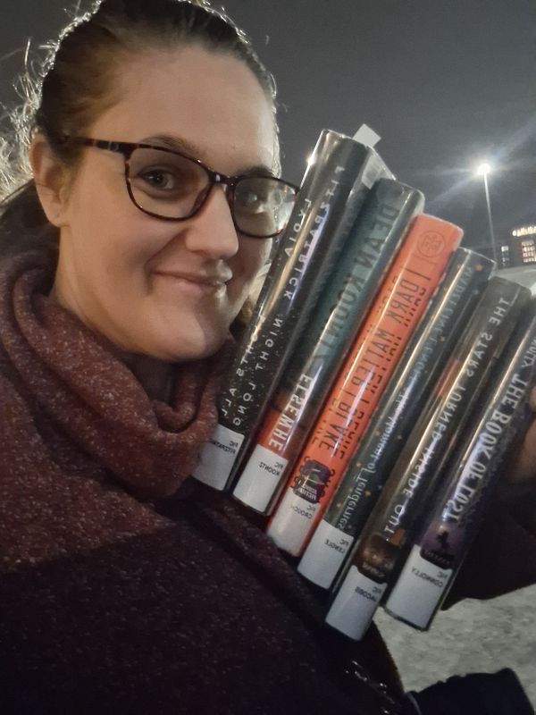 A book titled 'Life: The Science of Biology' 12th edition is illuminated by a warm light creating a glowing effect on its cover.