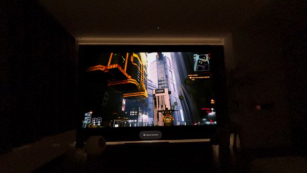A virtual reality gaming scene displayed on a screen, showcasing a futuristic cityscape.