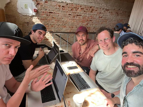 Street view of a modern building named 'Cursor Cafe' in Lisbon with outdoor seating and urban surroundings.