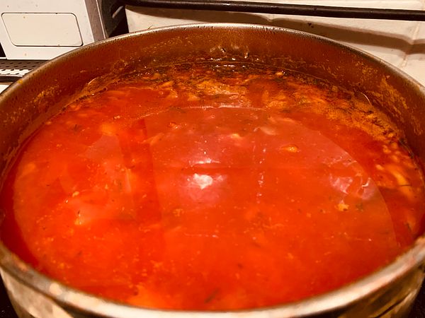 A pot of borscht simmering on the stove.