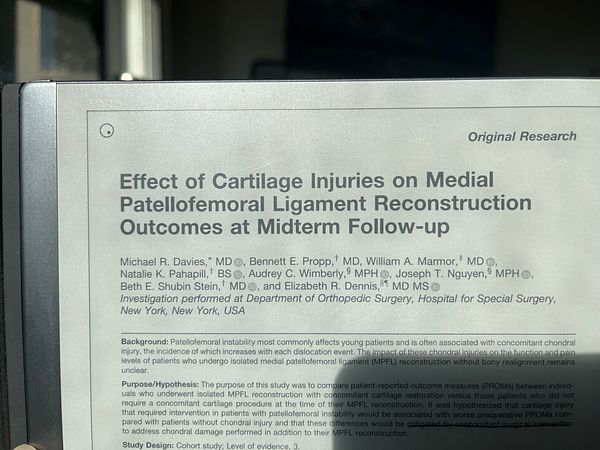 Photograph of a printed research paper titled 'Posterior Arthroscopic Assisted Suprascapular Nerve Decompression' with a detailed diagram of nerve anatomy and surgical area.