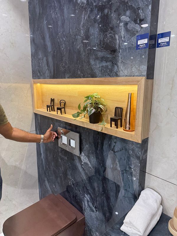 A modern interior space featuring a decorative shelf with miniature chairs and a plant.