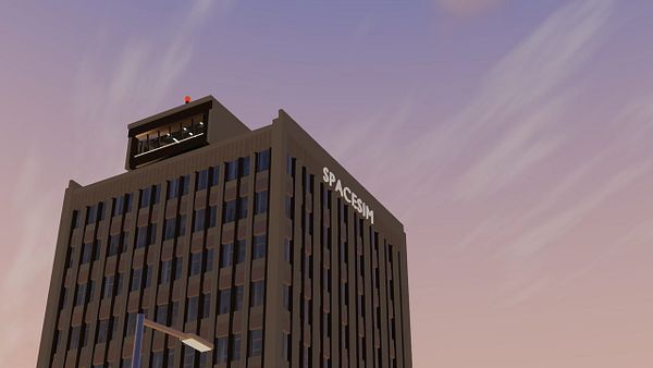 A digital rendering of a multi-story building labeled 'SPACESIM' against a dusky sky with subtle clouds.