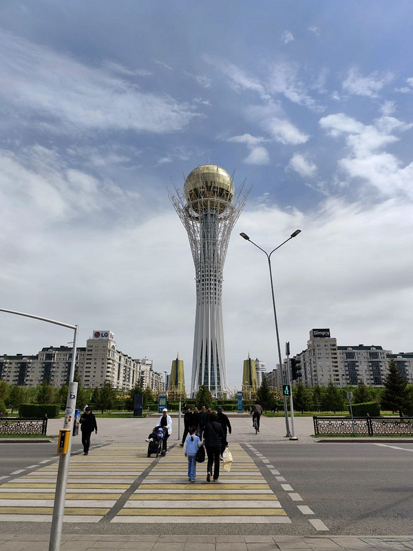 Scenic forest trail view with sunlit path surrounded by tall trees and greenery during a morning walk.