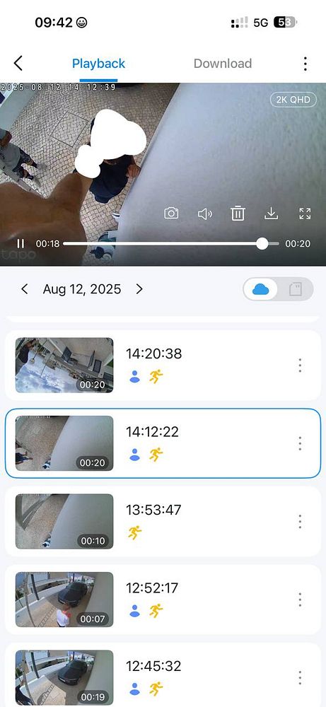 A security camera playback interface showing construction workers near a building.