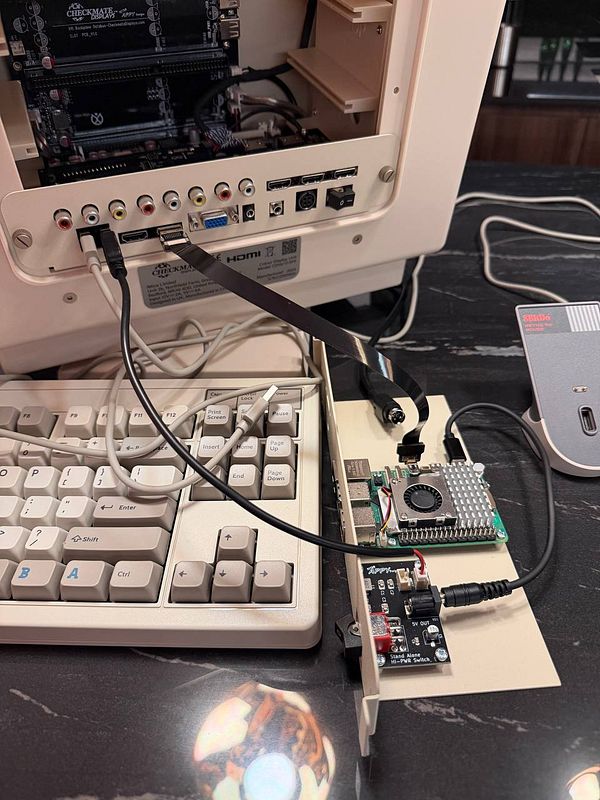 The image features a retro display setup with a Raspberry Pi and various connected components.